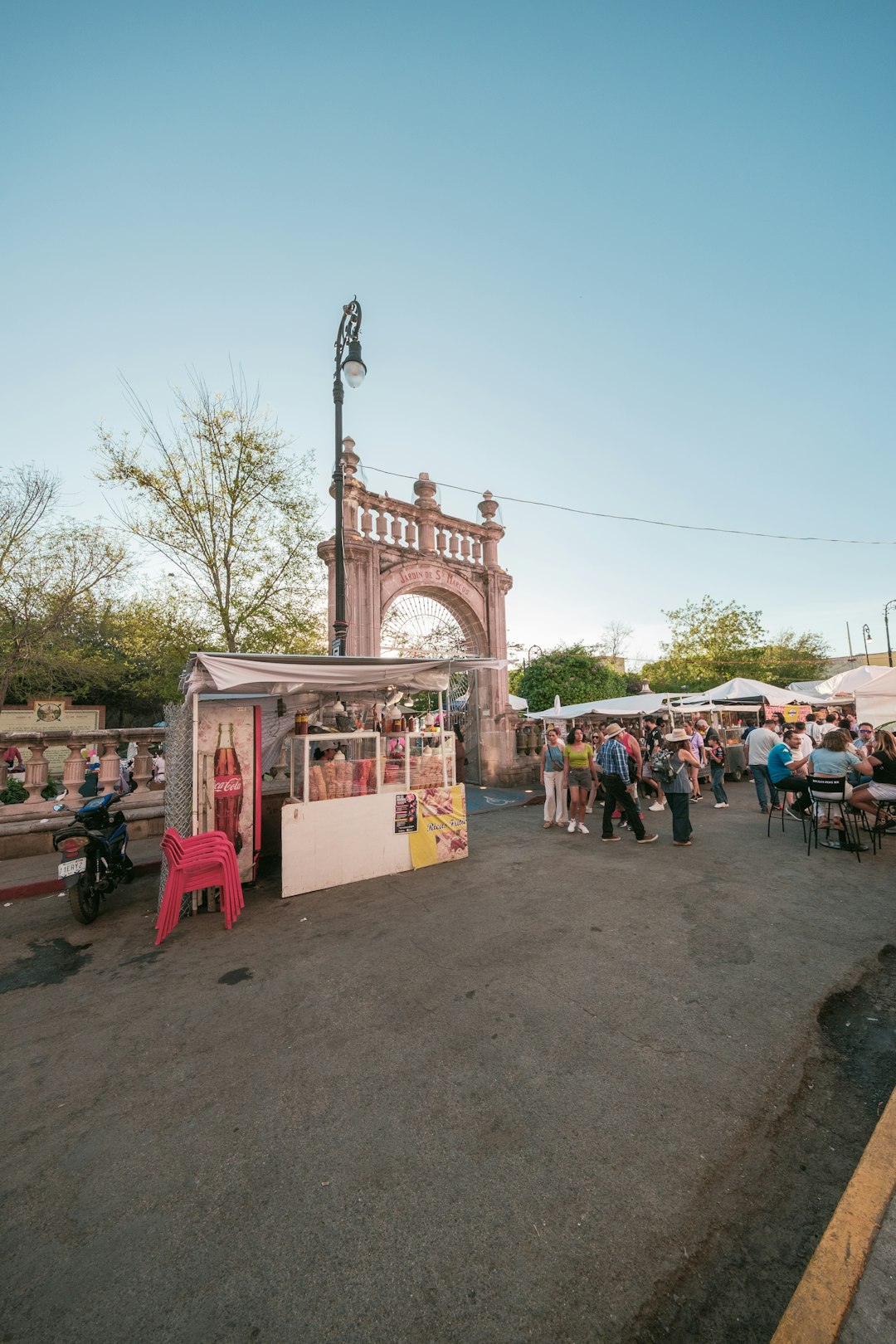Do You Need a SIM Card in Japan? Your Data Options Explained (2026) 13 shoppers gathered at an outdoor market beneath a stone archway