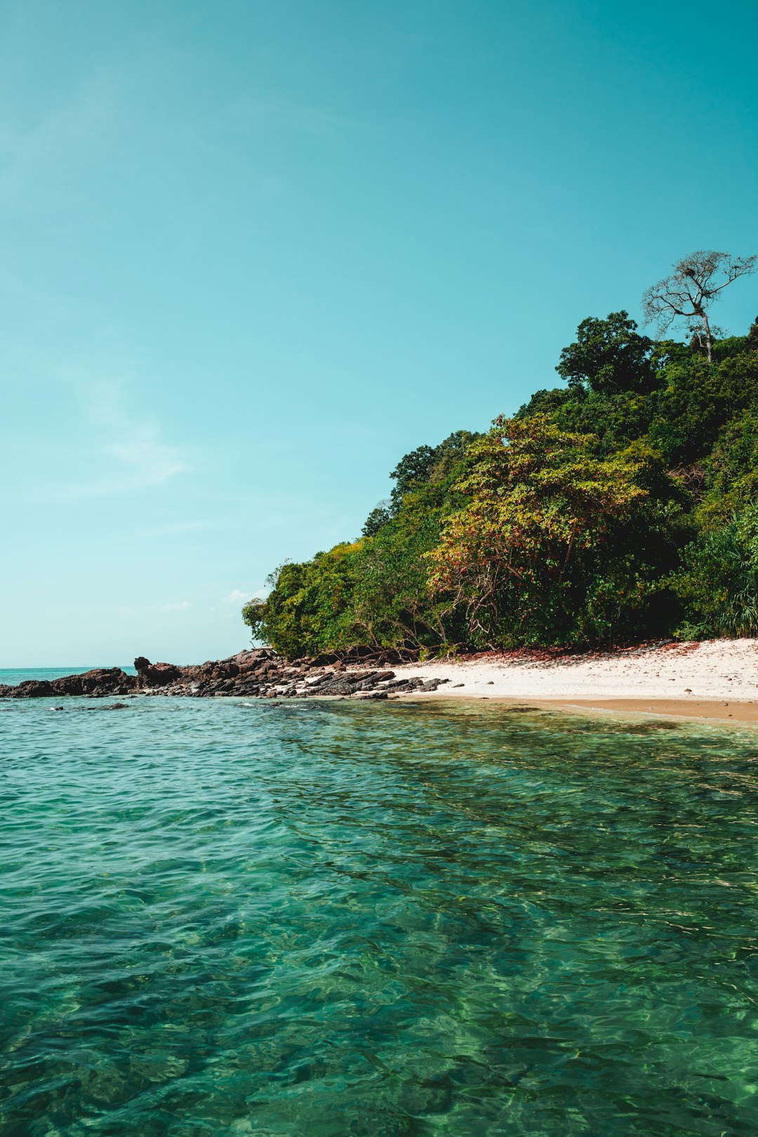 Where to Go in Southeast Asia in Summer: Best Destinations by Month 18 Clear blue water beach with a small island in the distance