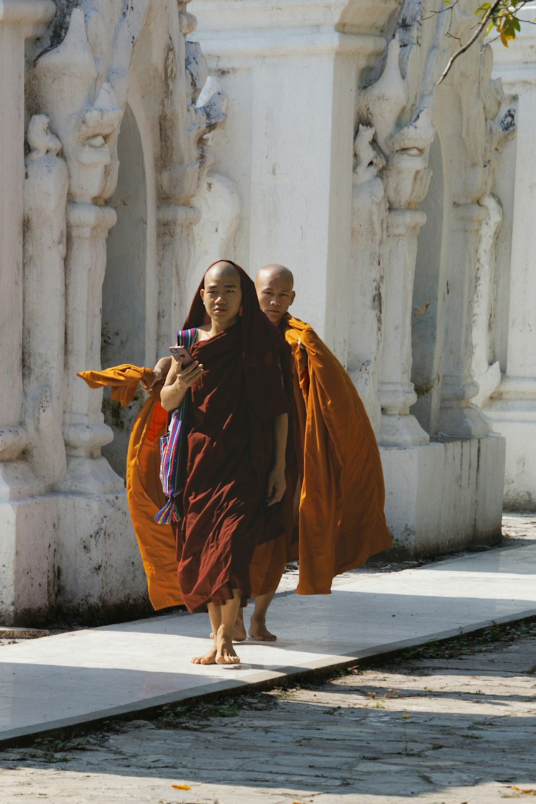 Where to Go in Southeast Asia in Summer: Best Destinations by Month 26 Two Buddhist monks walking near a white temple