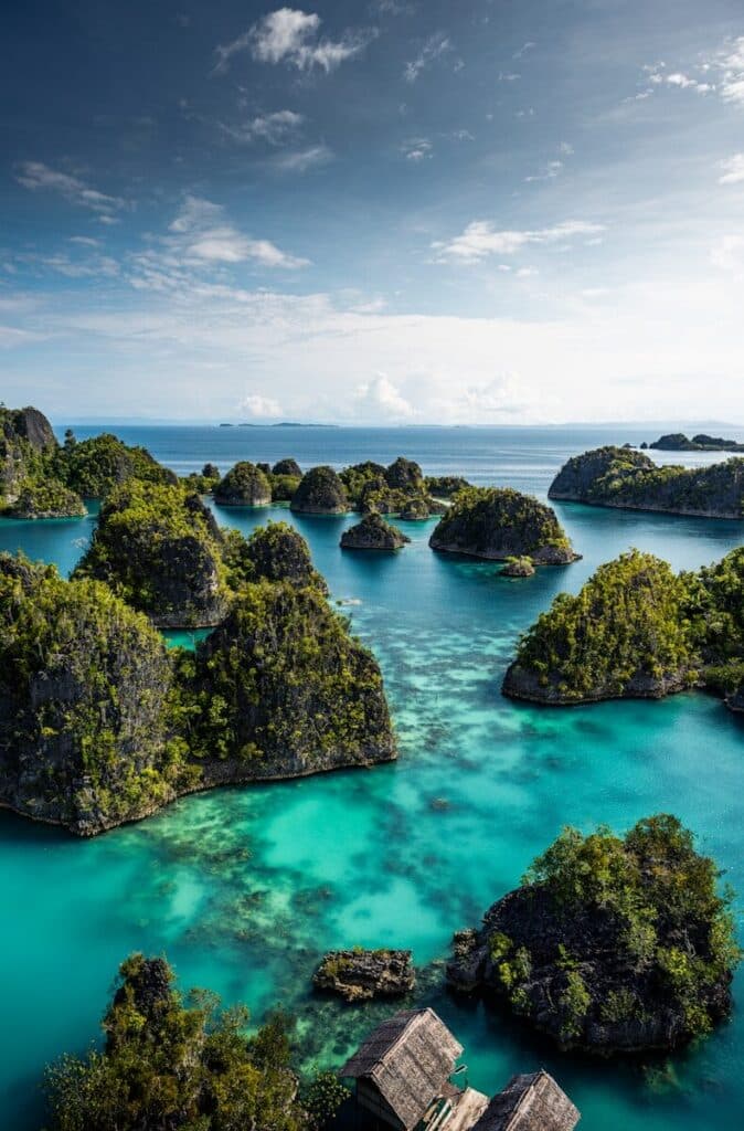 turquoise lagoon with jungle-covered limestone islands in Raja Ampat West Papua Indonesia