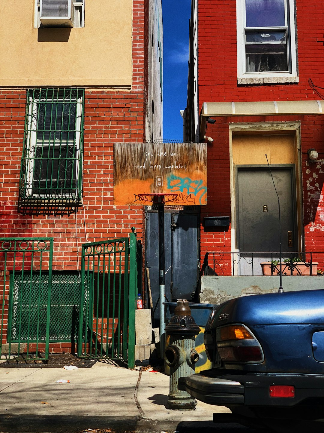 Car parked beside a brown concrete building in Brooklyn