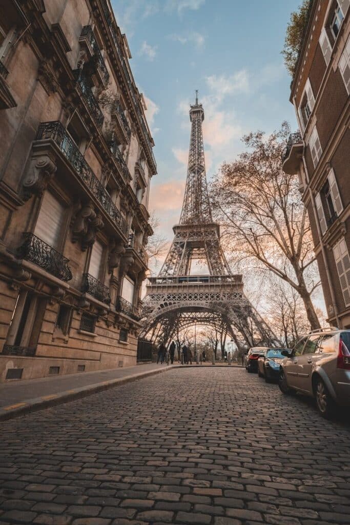 eSIM or Physical SIM in France? Pros, Cons & Best Pick for Travellers 2026 2 Eiffel Tower street view in Paris with autumn trees and parked cars