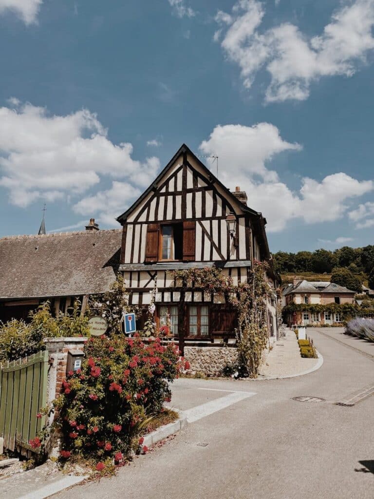 eSIM or Physical SIM in France? Pros, Cons & Best Pick for Travellers 2026 11 Traditional half-timbered house in Normandy France with climbing roses and blue sky