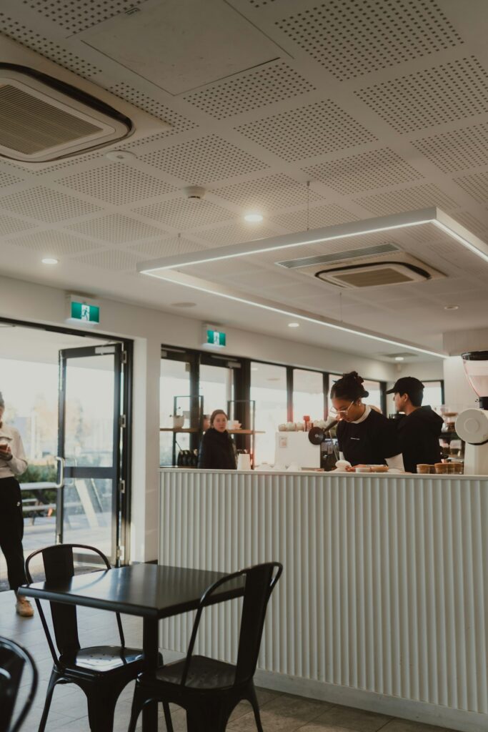 Baristas preparing drinks in a bright Australian cafe