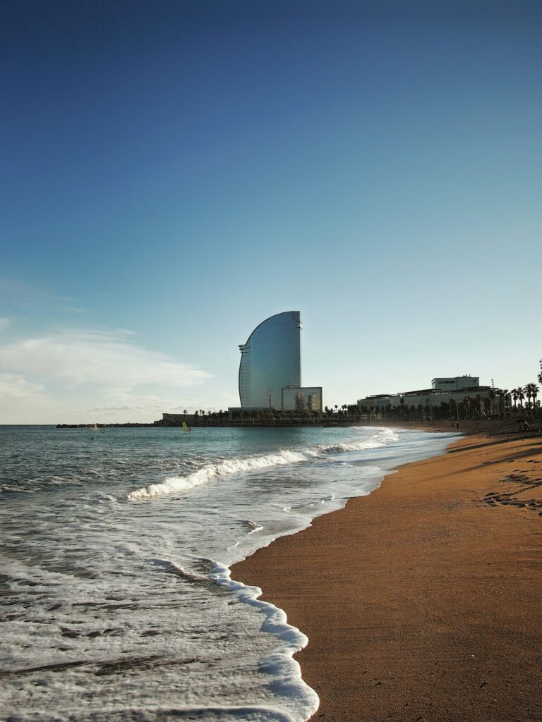 People walking along Barceloneta beach in Barcelona