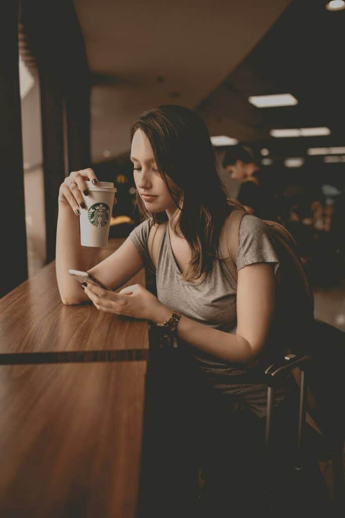 Traveler checking a phone while resting during a trip