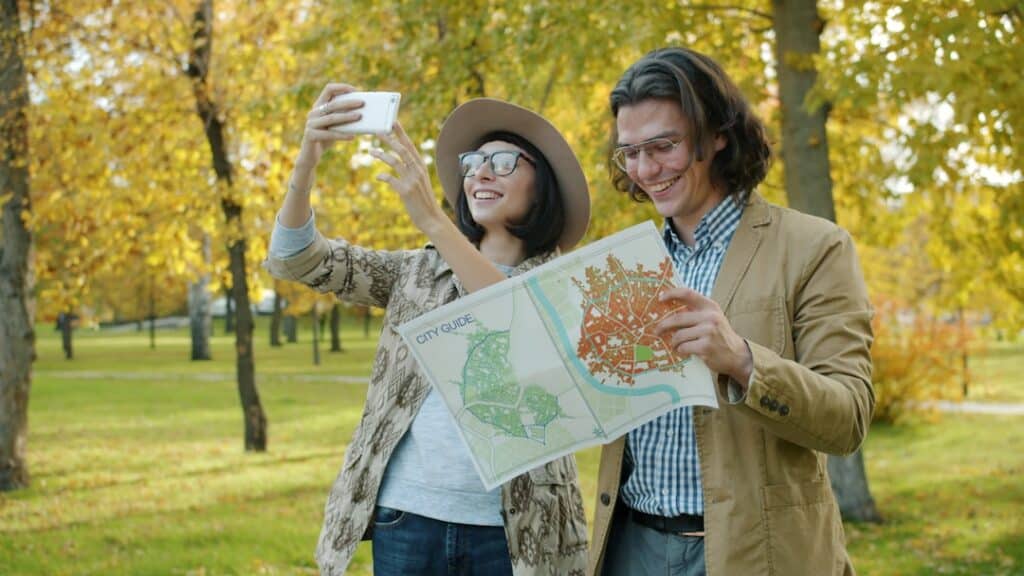 joyful students looking at a map while exploring a Canadian city