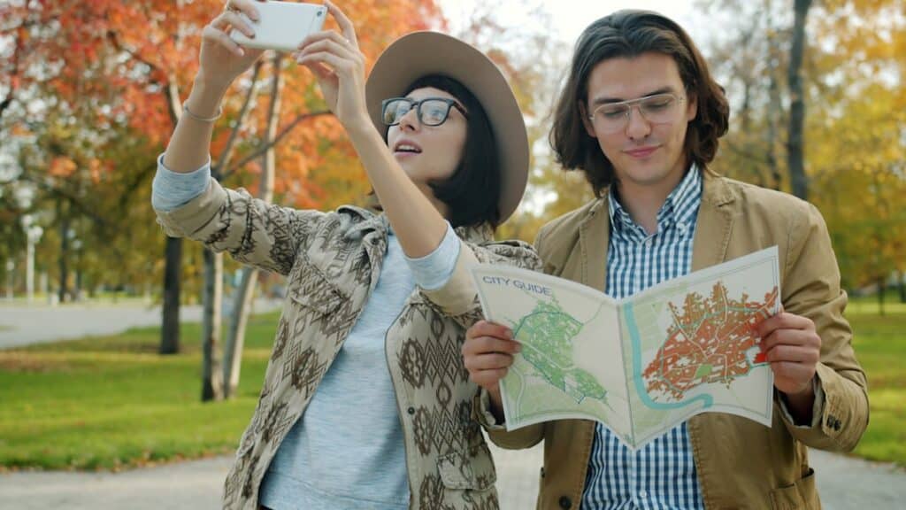 joyful tourists looking at a map while researching prepaid SIM options