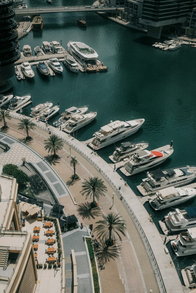 Boats docked in Dubai Marina beneath tall buildings