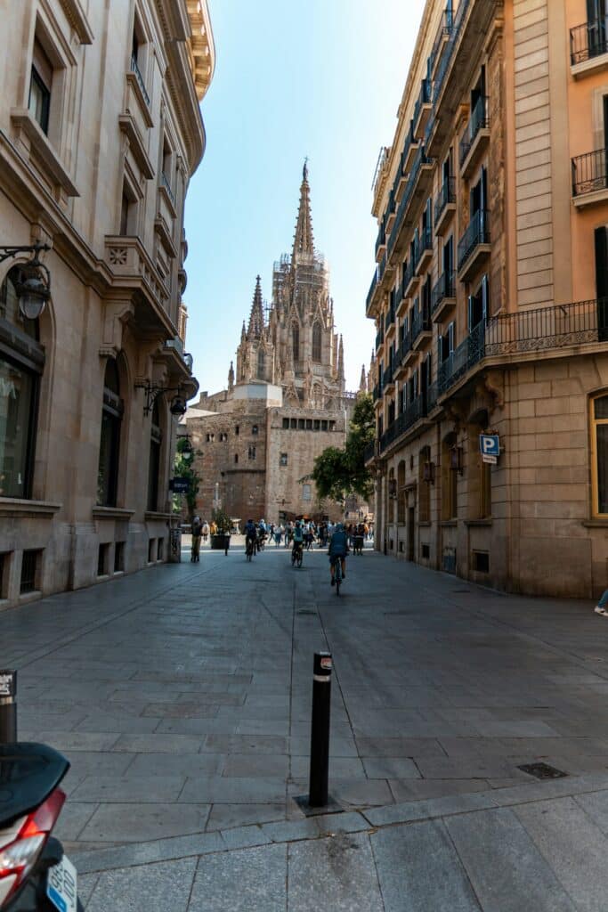 Barcelona street leading toward a cathedral in the distance