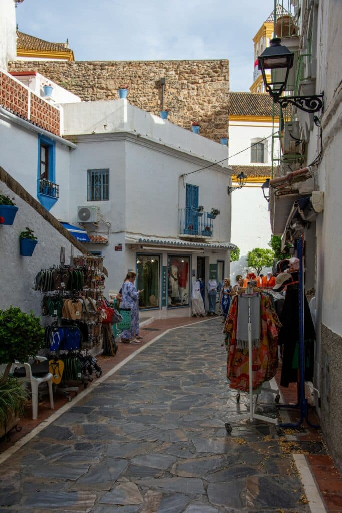 A narrow cobblestone street lined with white buildings in Andalusia