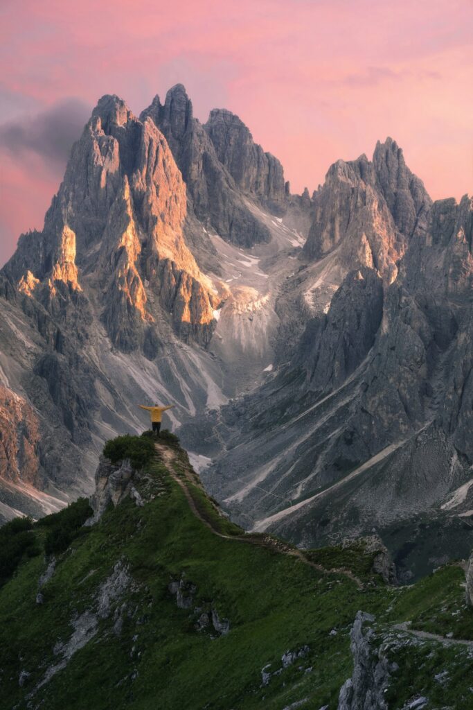 A small house perches atop a ridge in the Dolomites mountain range