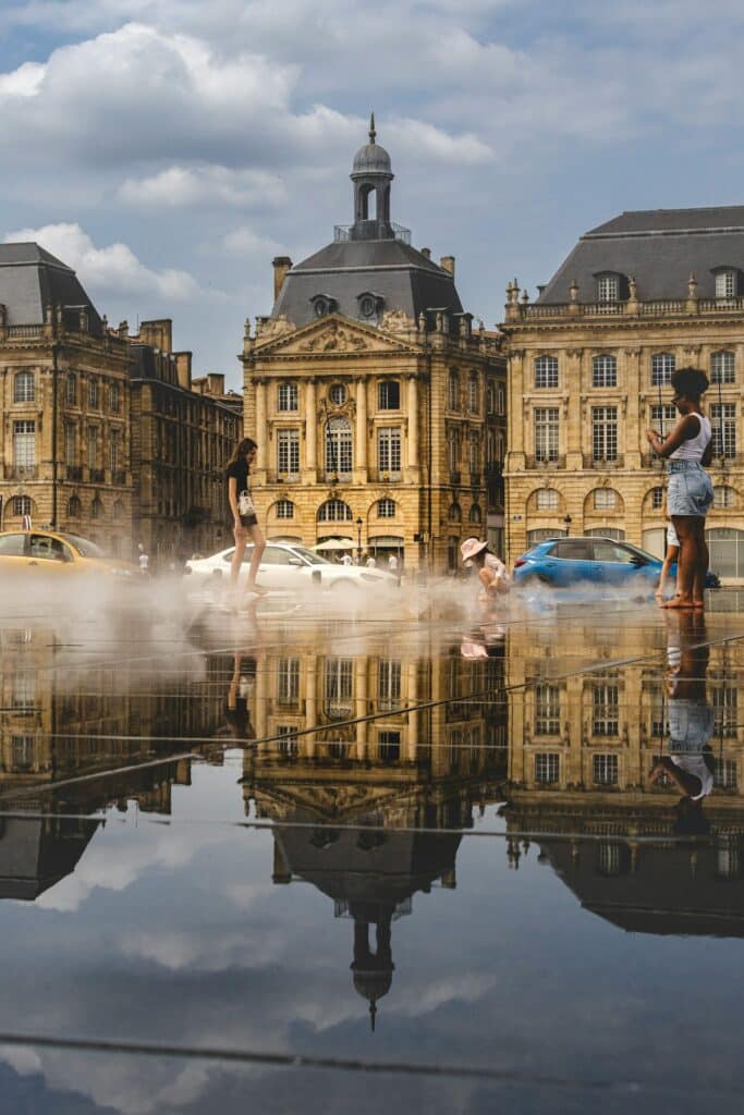 People cooling off in a misty European plaza