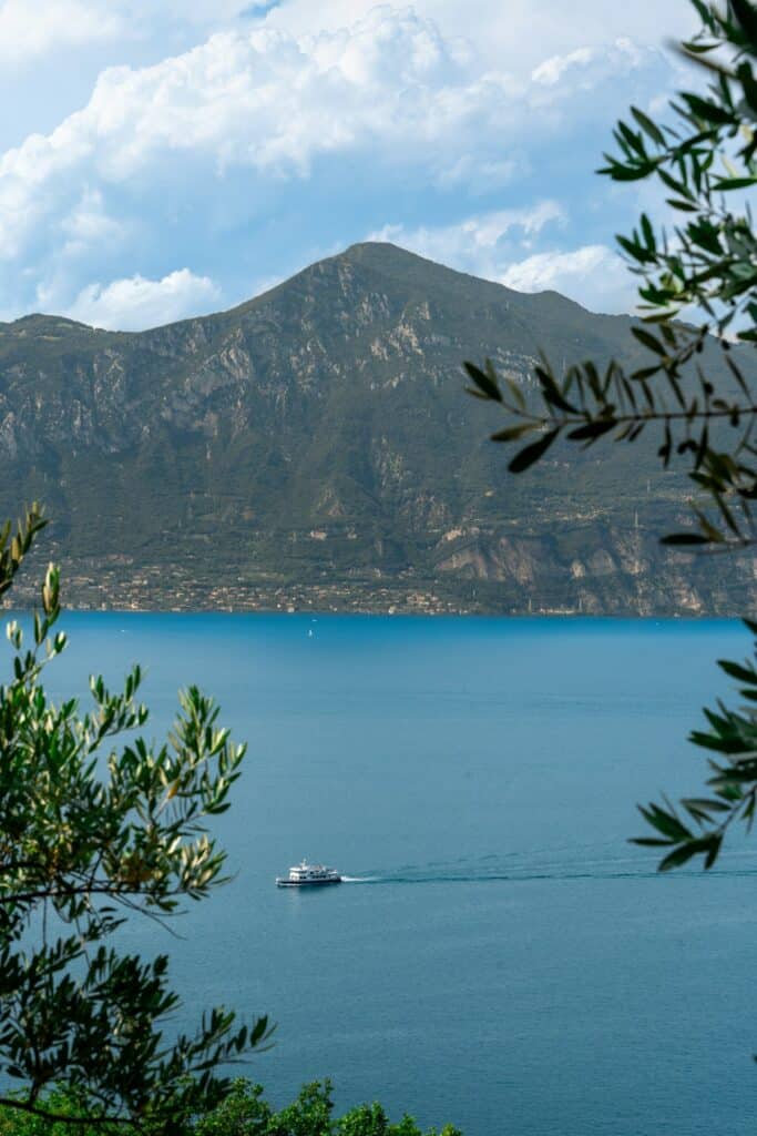 A ferry crosses Lake Garda toward the town of Garda
