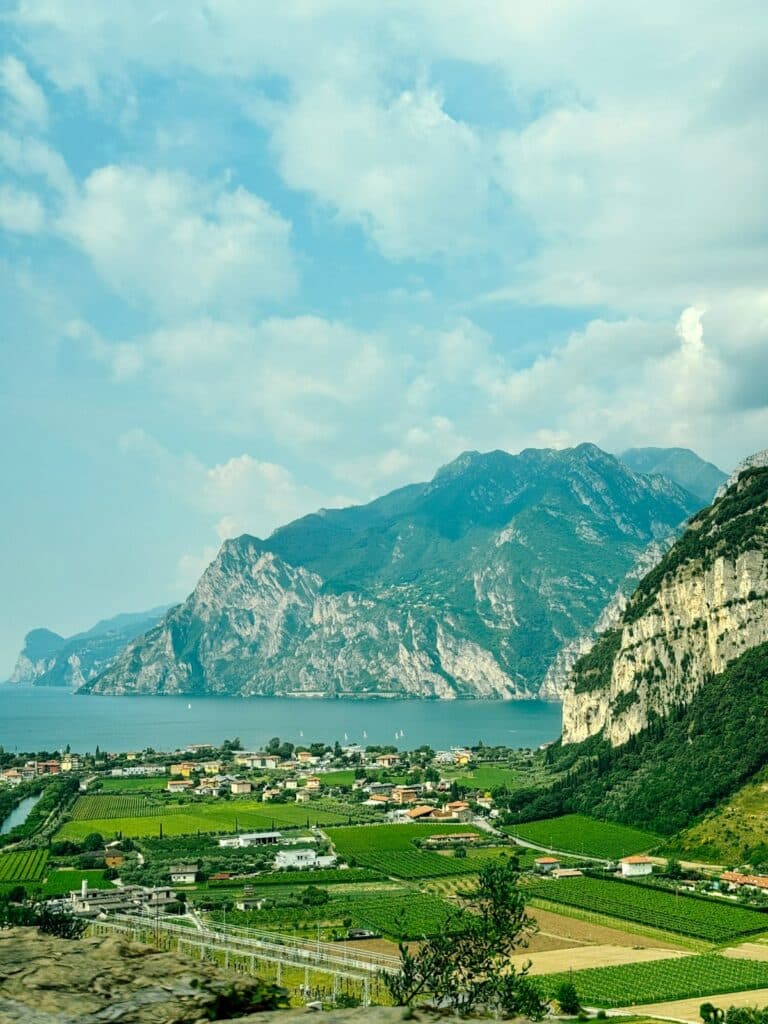 Green fields surround a village on the shore of Lake Garda