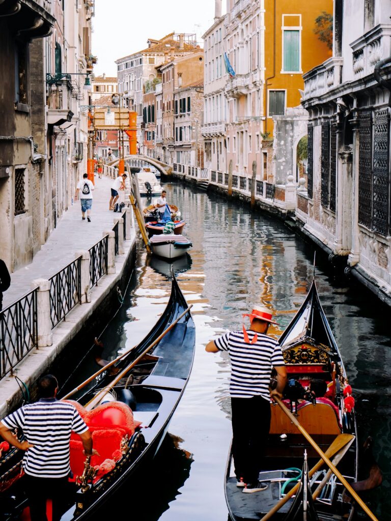 Gondolas moored along a narrow canal in Venice