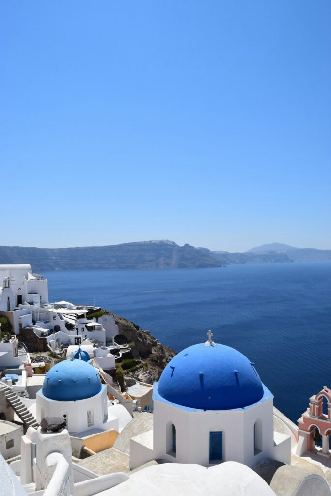 Blue-domed churches in Santorini during the day