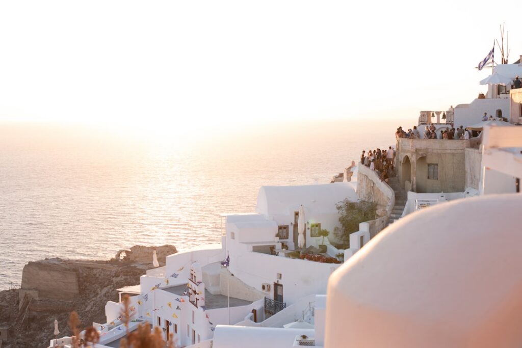 White buildings on a cliff at sunset in Santorini