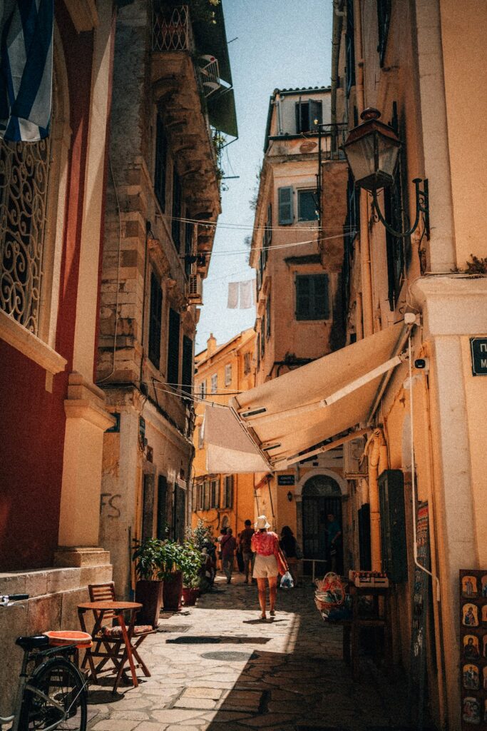 Narrow street in Corfu Town lined with historic buildings and shopfronts