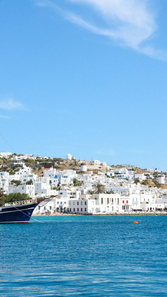 Alternatives to Santorini: Less Crowded Greek Islands Worth Visiting 20 Sailboat on the water with a Greek island town behind it