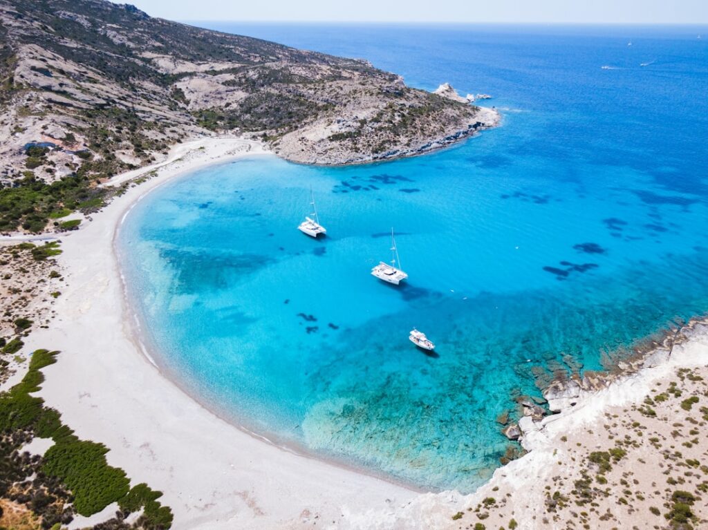 Alternatives to Santorini: Less Crowded Greek Islands Worth Visiting 8 Small boats anchored in a quiet bay on Milos island