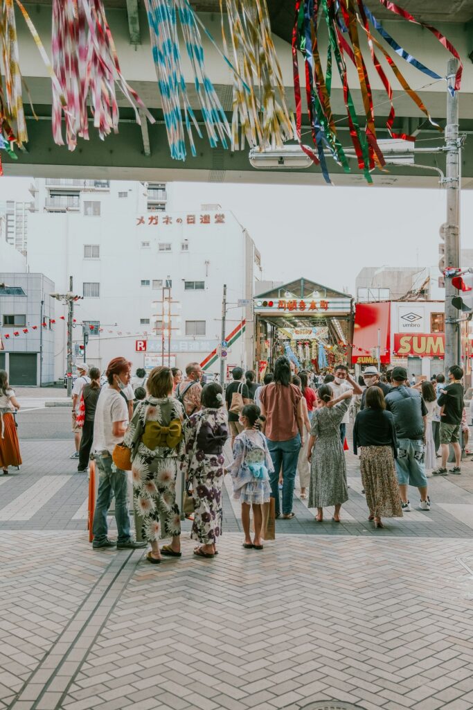 A group of people stands together on a city street