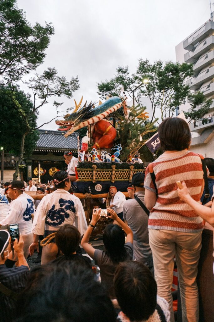 A crowd gathers around a decorated float during a summer festival