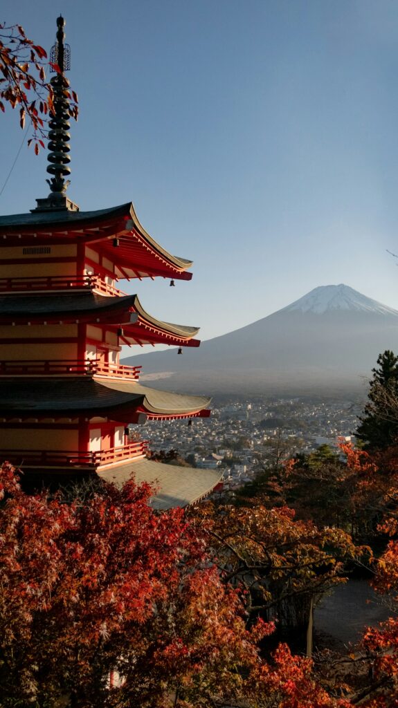 A temple sits surrounded by trees as early autumn begins