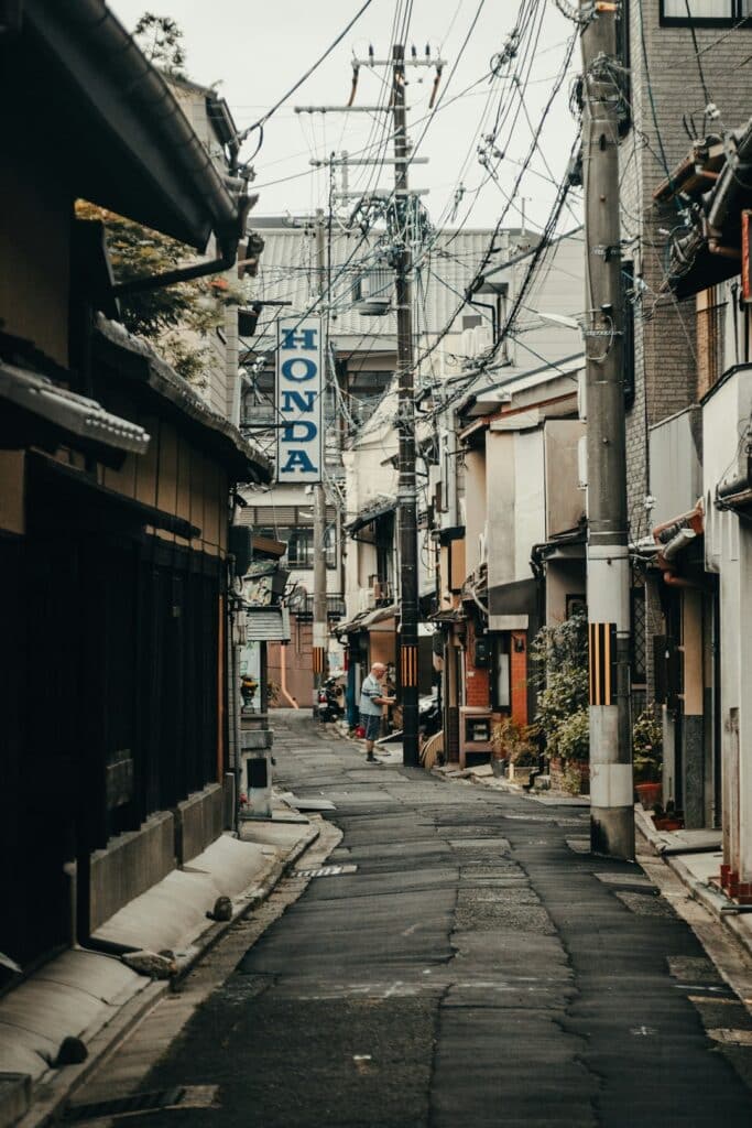 Do You Need a SIM Card in Japan? Your Data Options Explained (2026) 11 narrow city street crossed by overhead power lines
