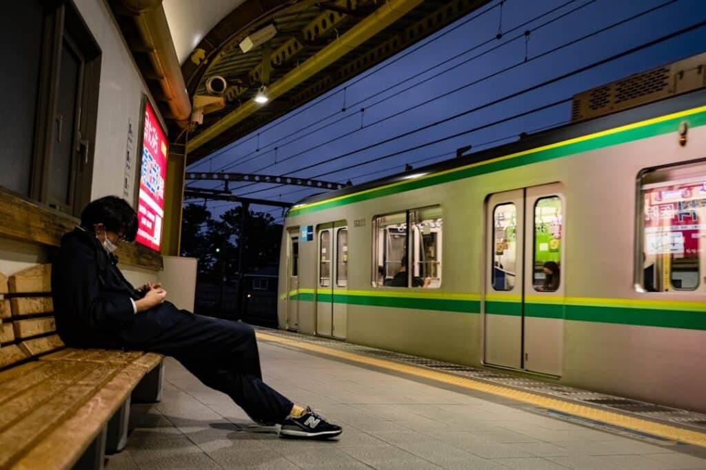 Do You Need a SIM Card in Japan? Your Data Options Explained (2026) 20 man sitting on a bench beside a train