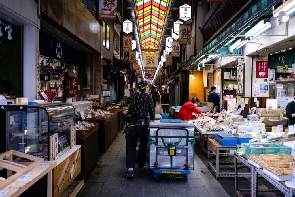 Do You Need a SIM Card in Japan? Your Data Options Explained (2026) 7 man pushing a cart through a narrow market street
