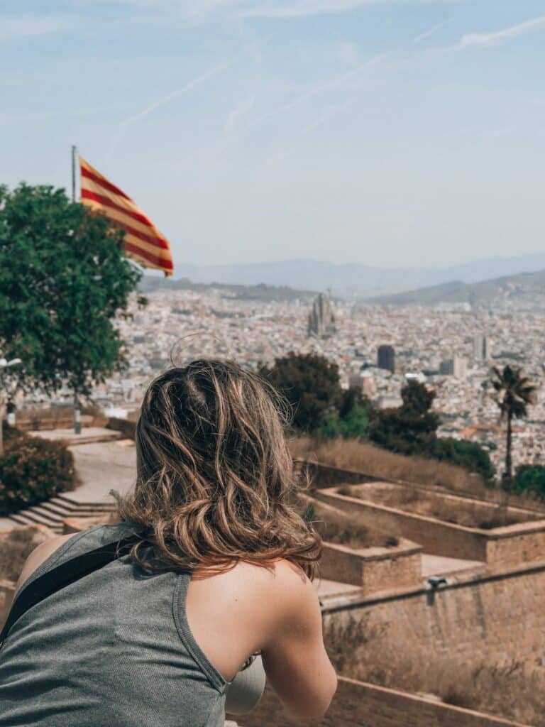 Visitor overlooking Barcelona from a Montjuïc hillside