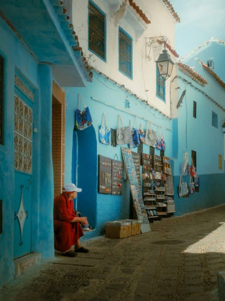 vendor selling merchandise in a colorful Moroccan street market