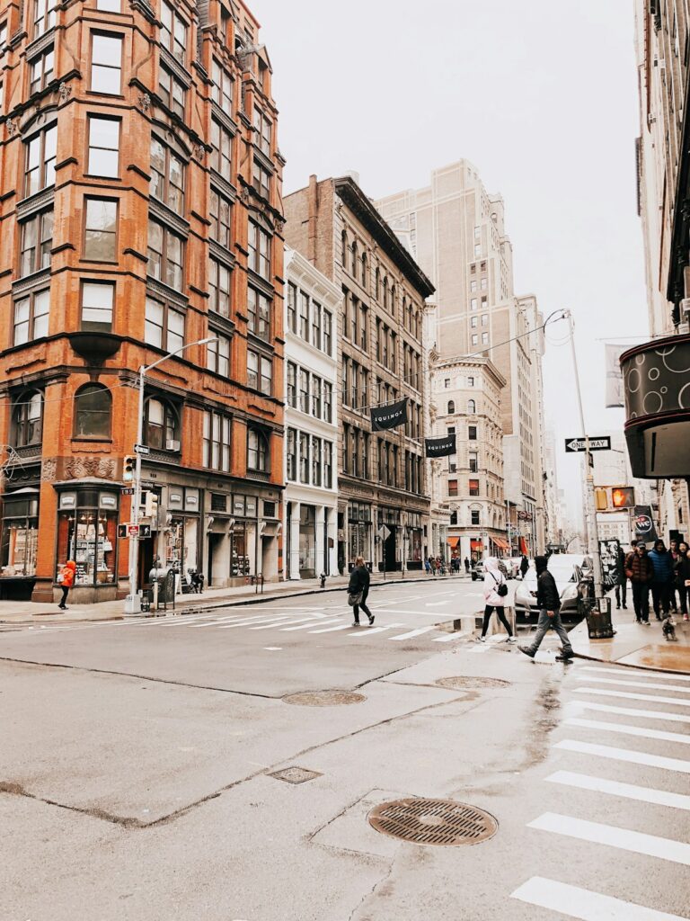 Travelers walking along a quiet New York City side street