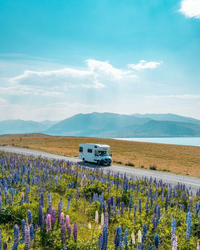 Best Internet Options for Travellers in New Zealand (2026) 15 campervan parked beside a green field in New Zealand