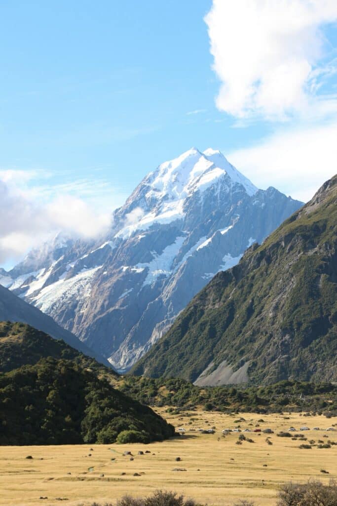 Best Internet Options for Travellers in New Zealand (2026) 2 snow-capped mountain rising above a green New Zealand valley