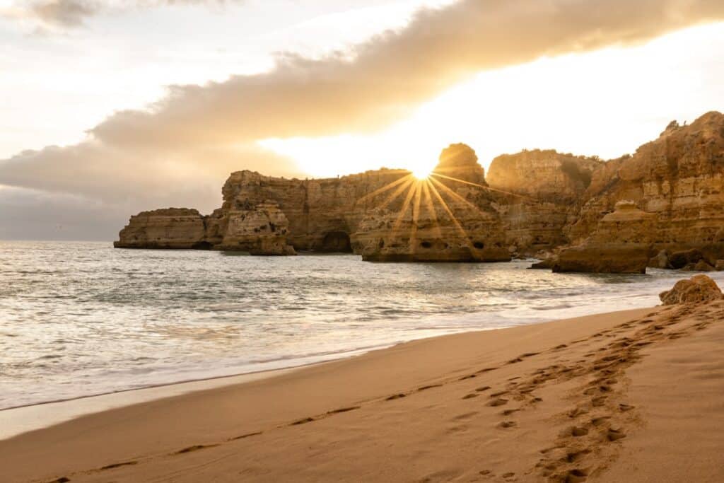 Best Beaches in Portugal: A Guide to the Country's Top Coastal Spots 2 Layered limestone cliffs along the Algarve coastline meeting the Atlantic