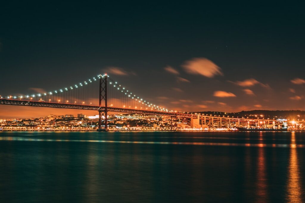 Best Beaches in Portugal: A Guide to the Country's Top Coastal Spots 14 The 25 de Abril Bridge spanning the Tagus River in Lisbon