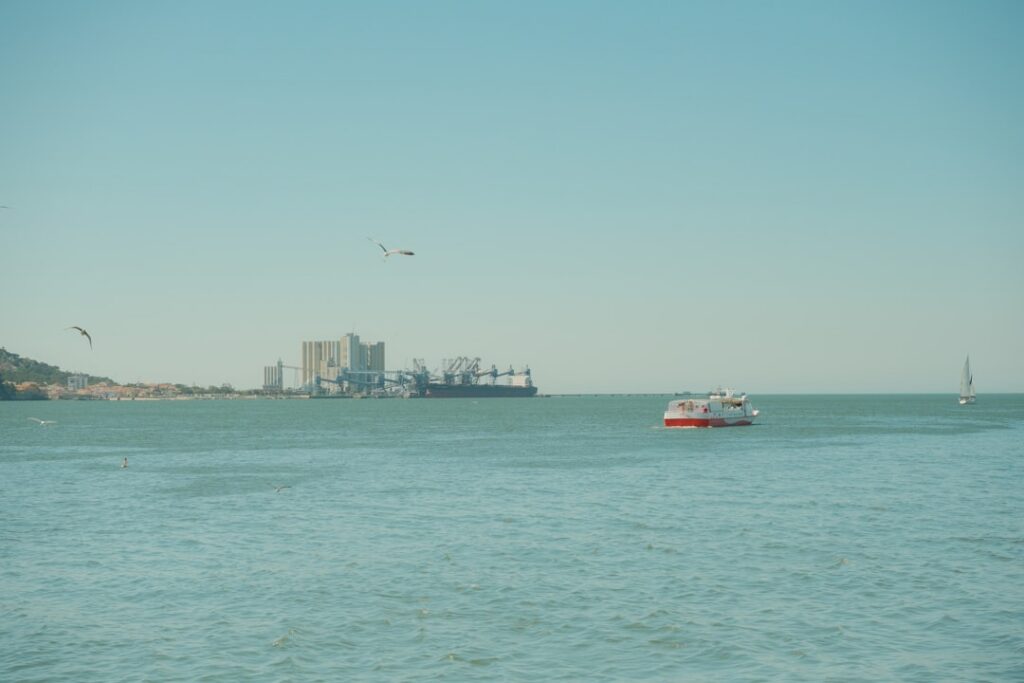 Best Beaches in Portugal: A Guide to the Country's Top Coastal Spots 39 Boats on the Tagus River with the city of Lisbon behind