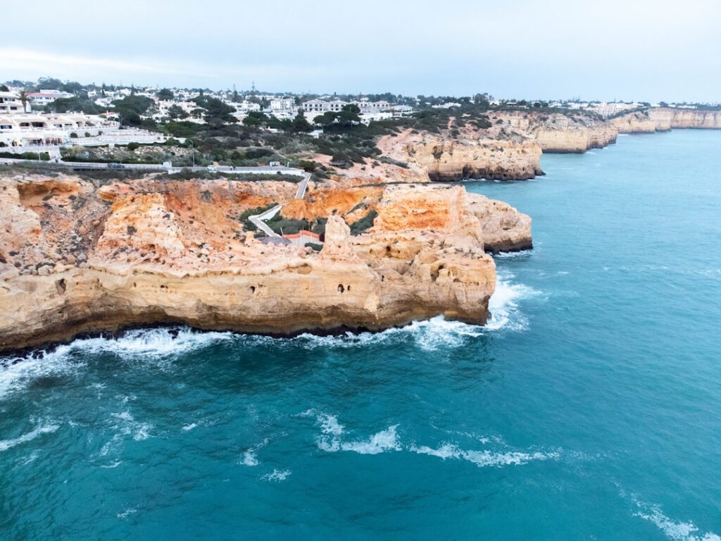 Best Beaches in Portugal: A Guide to the Country's Top Coastal Spots 6 Aerial view of a rocky Algarve coastline near a coastal town