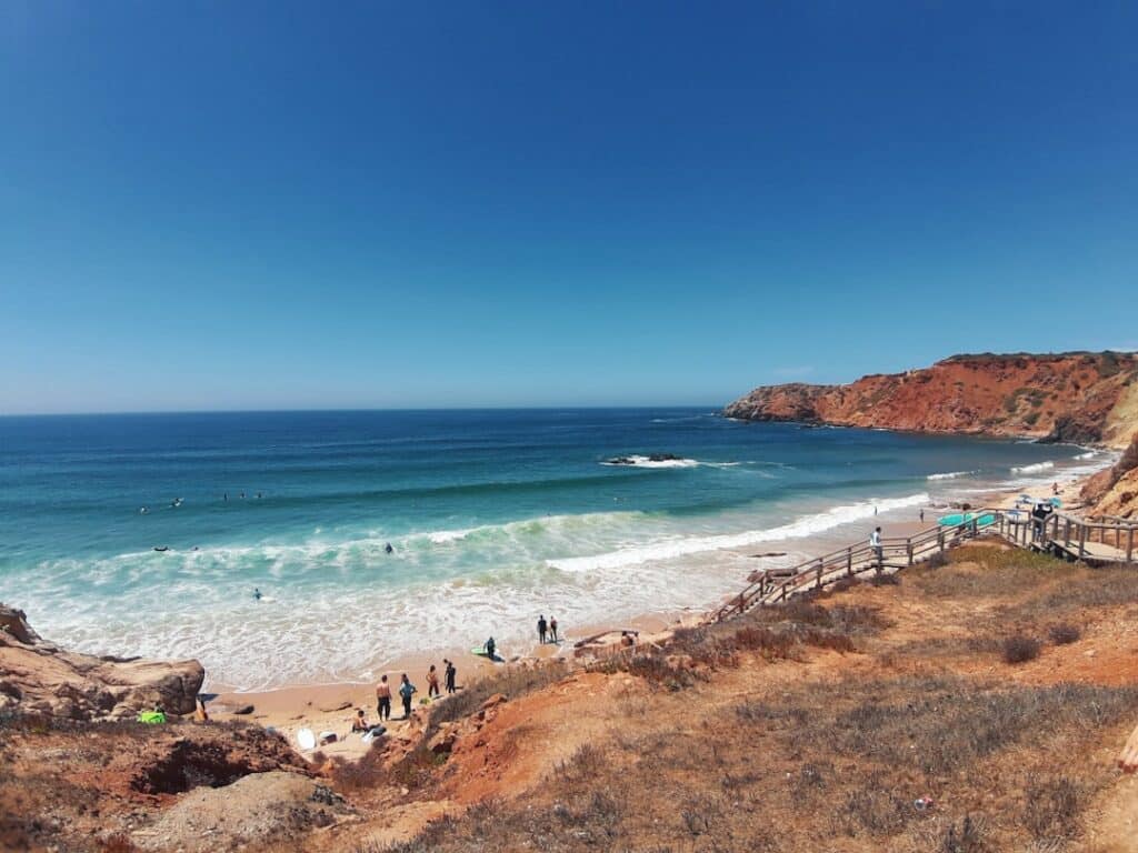 Best Beaches in Portugal: A Guide to the Country's Top Coastal Spots 9 Praia do Amado with waves rolling onto a wide sandy beach