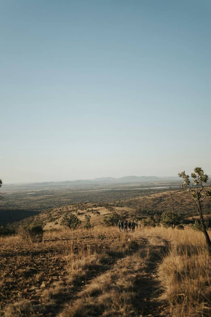 group of travelers walking down a dirt road in South Africa