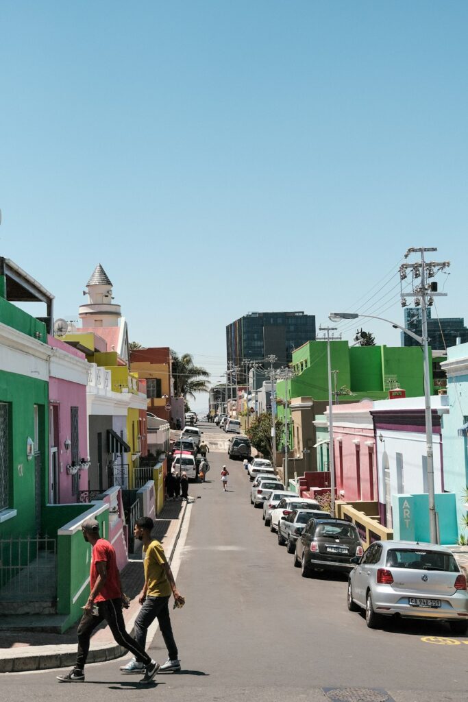 travelers crossing a busy street in a South African city