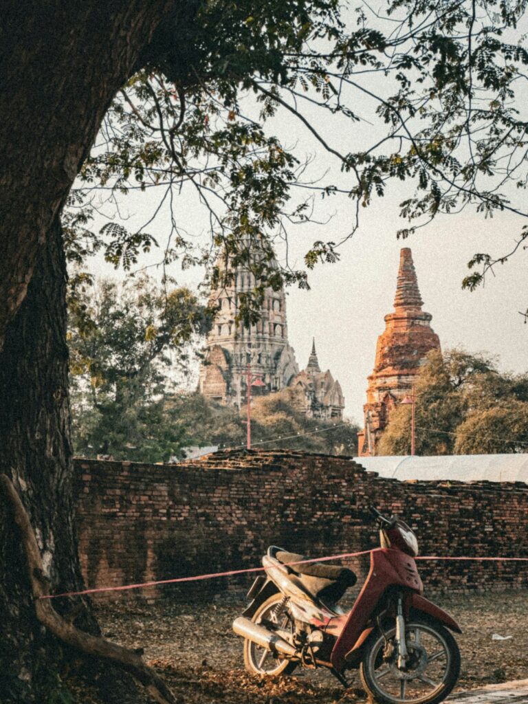 Motorbike parked near ancient temple ruins in Southeast Asia