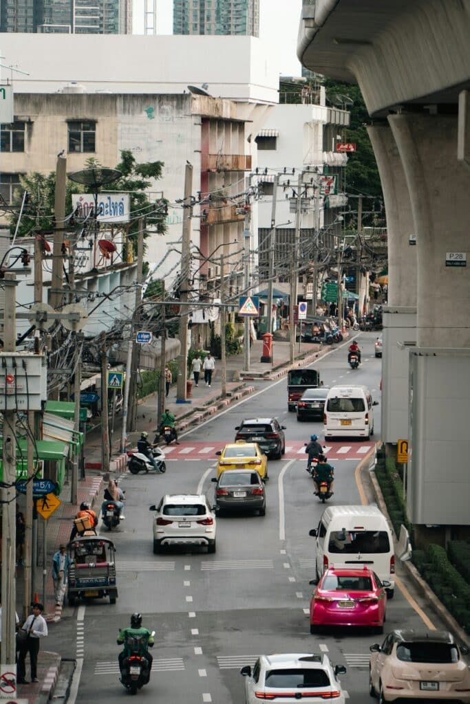 Busy city street with cars and motorcycles in Southeast Asia