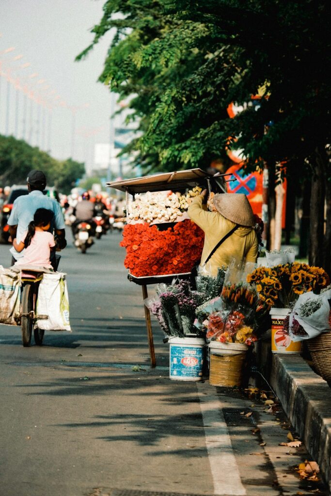 Where to Go in Southeast Asia in Summer: Best Destinations by Month 25 Man riding a bicycle loaded with fruit baskets in Vietnam