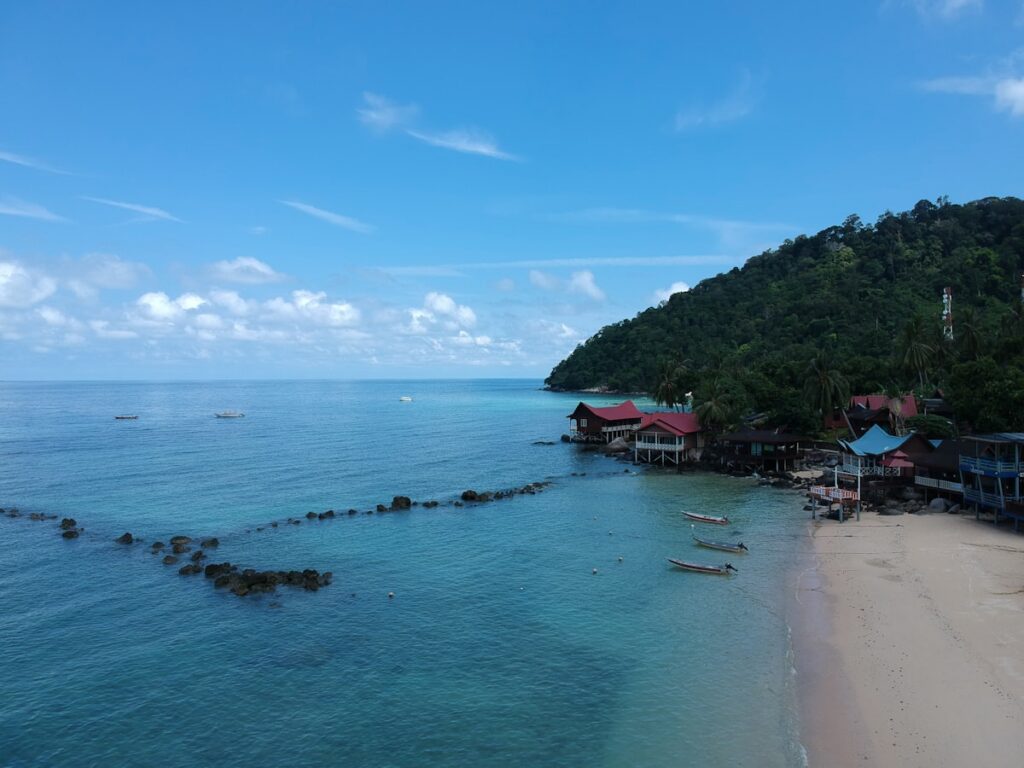 Where to Go in Southeast Asia in Summer: Best Destinations by Month 5 Travelers relaxing on a quiet Malaysian island beach