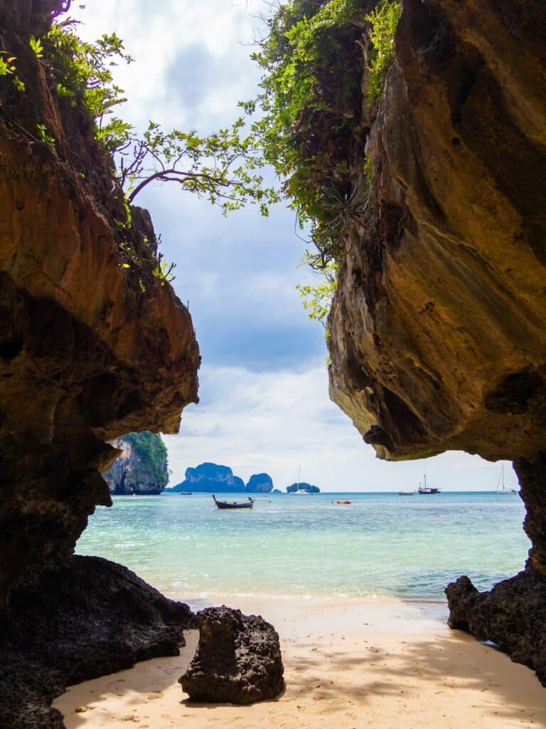 Where to Go in Southeast Asia in Summer: Best Destinations by Month 19 Beach view framed between two large limestone rocks in Krabi