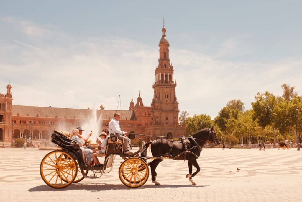 10-Day Travel Route Through Spain: The Essential Itinerary 11 Horse-drawn carriage passing through a Seville street