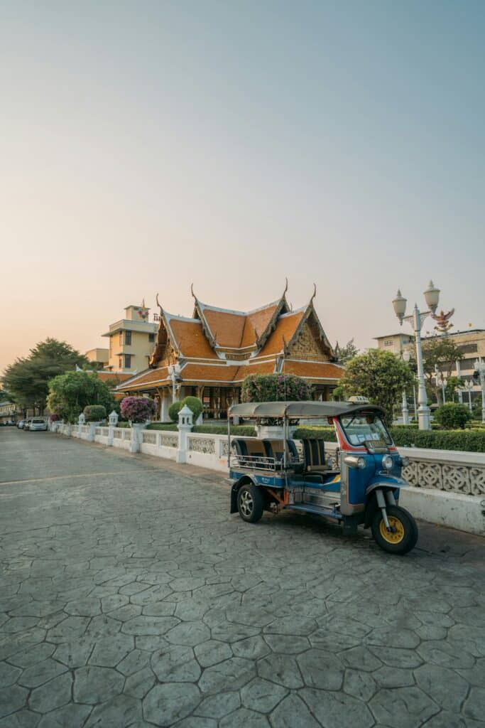 Blue auto-rickshaw parked on a street in Thailand